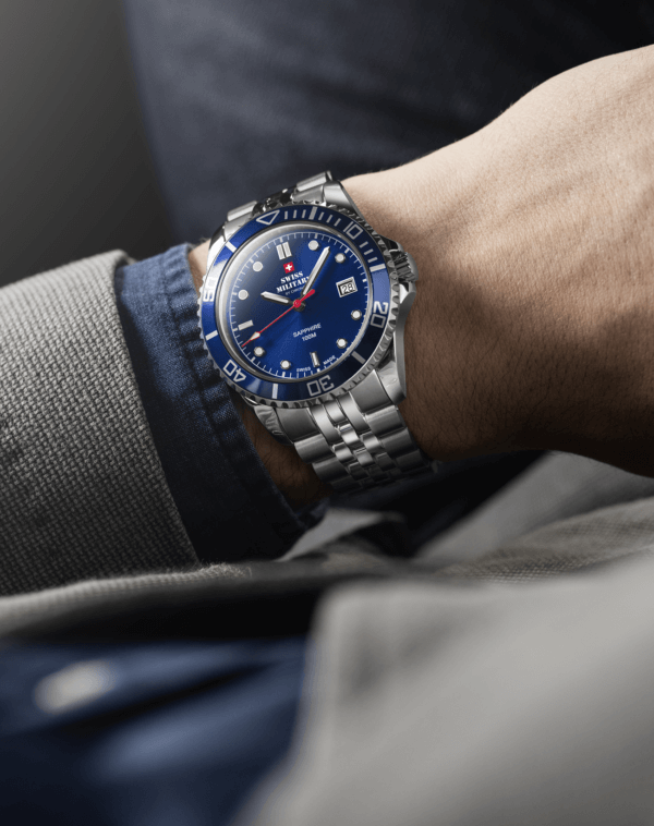 Swiss Military SM34109.02 Men's Sports Watch Blue Steel on wrist, featuring a blue sunray dial, blue rotating bezel, and stainless steel bracelet.